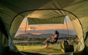 woman sitting outside of tent